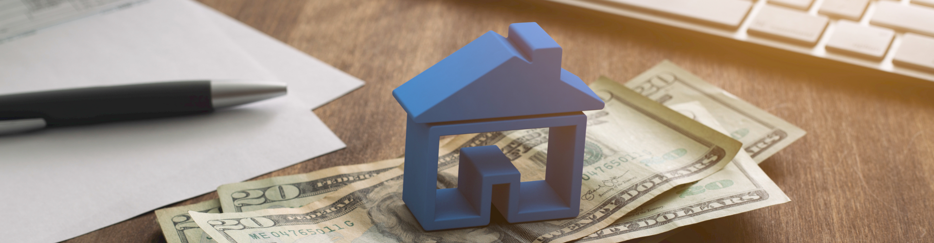 A blue cube on a pile of money.