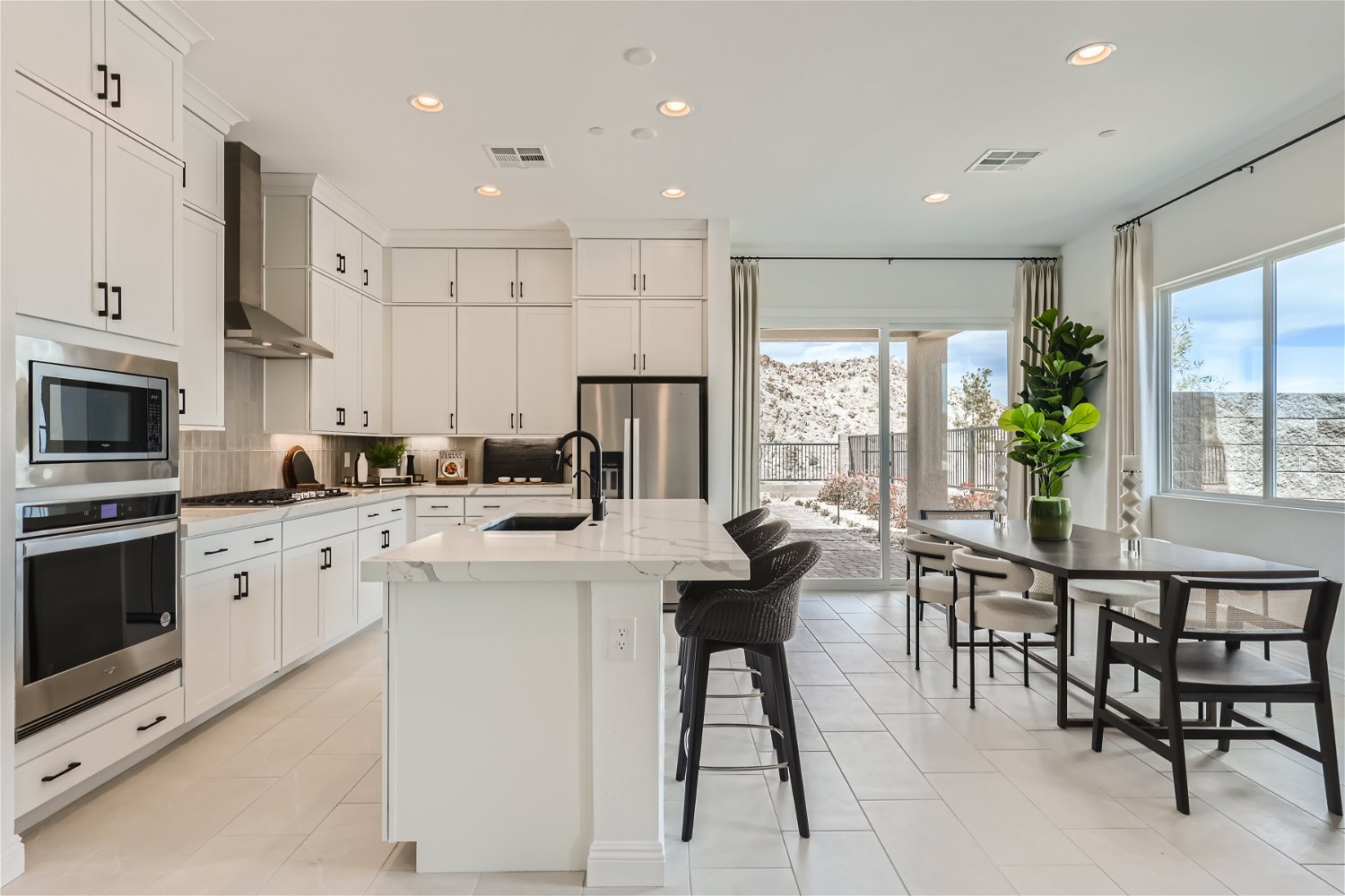 A kitchen with white cabinets.
