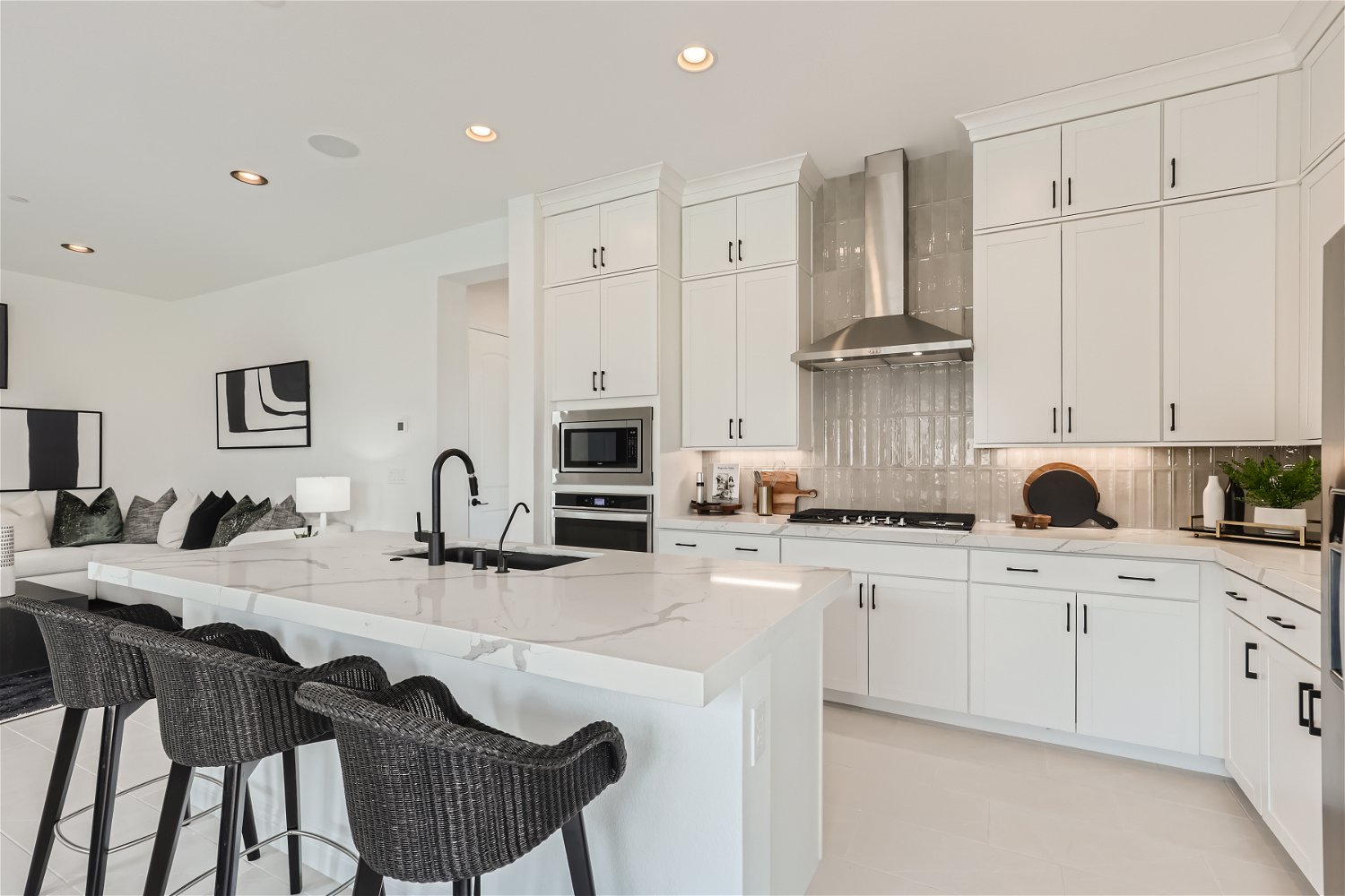 A kitchen with white cabinets.