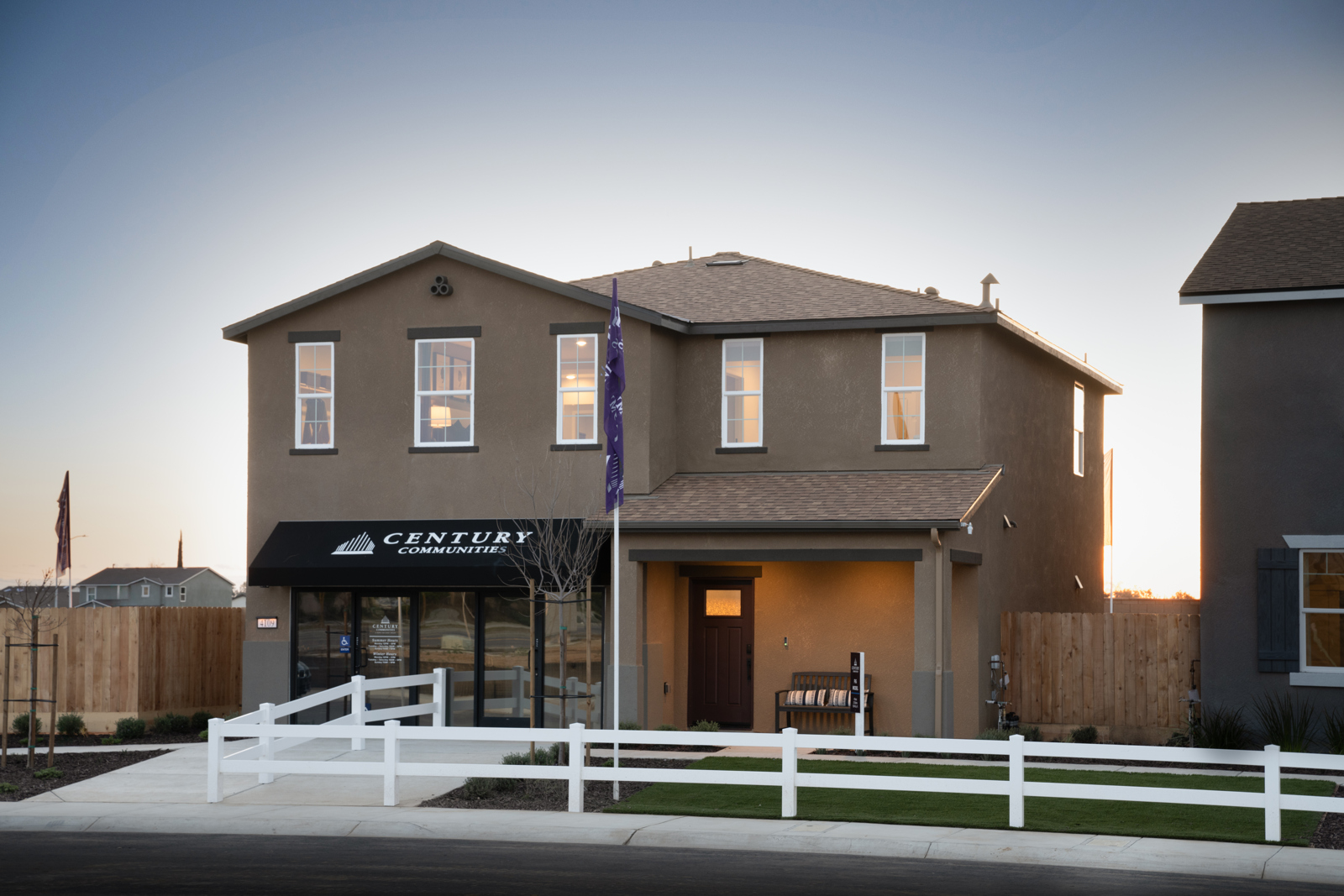 A building with a white fence in front of it.