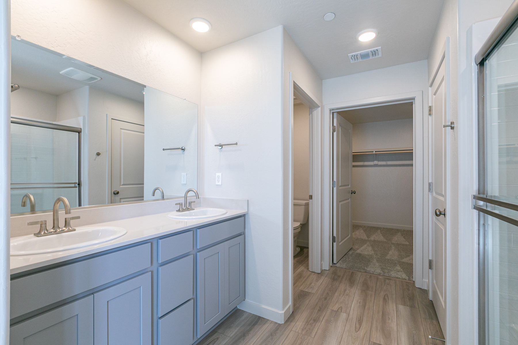 A bathroom with white cabinets.