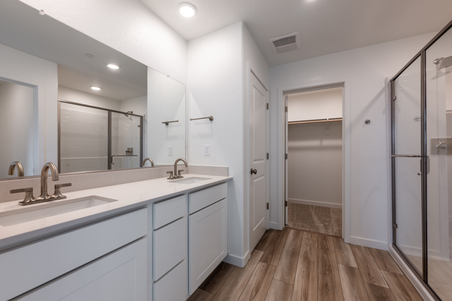 A bathroom with white cabinets.