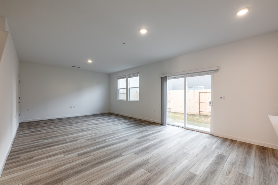 A room with a wood floor and a glass door.