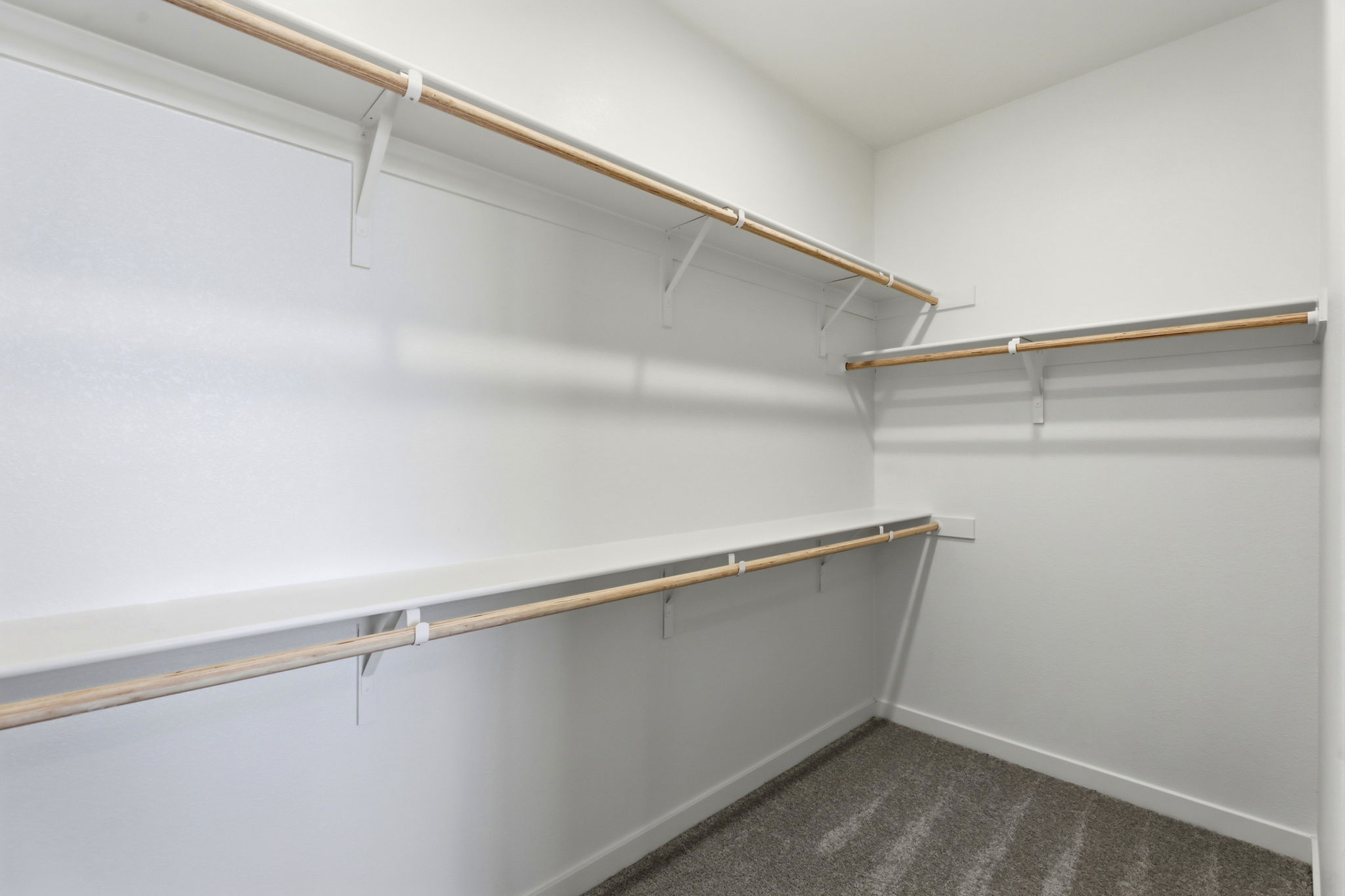 A white wall with a metal railing.