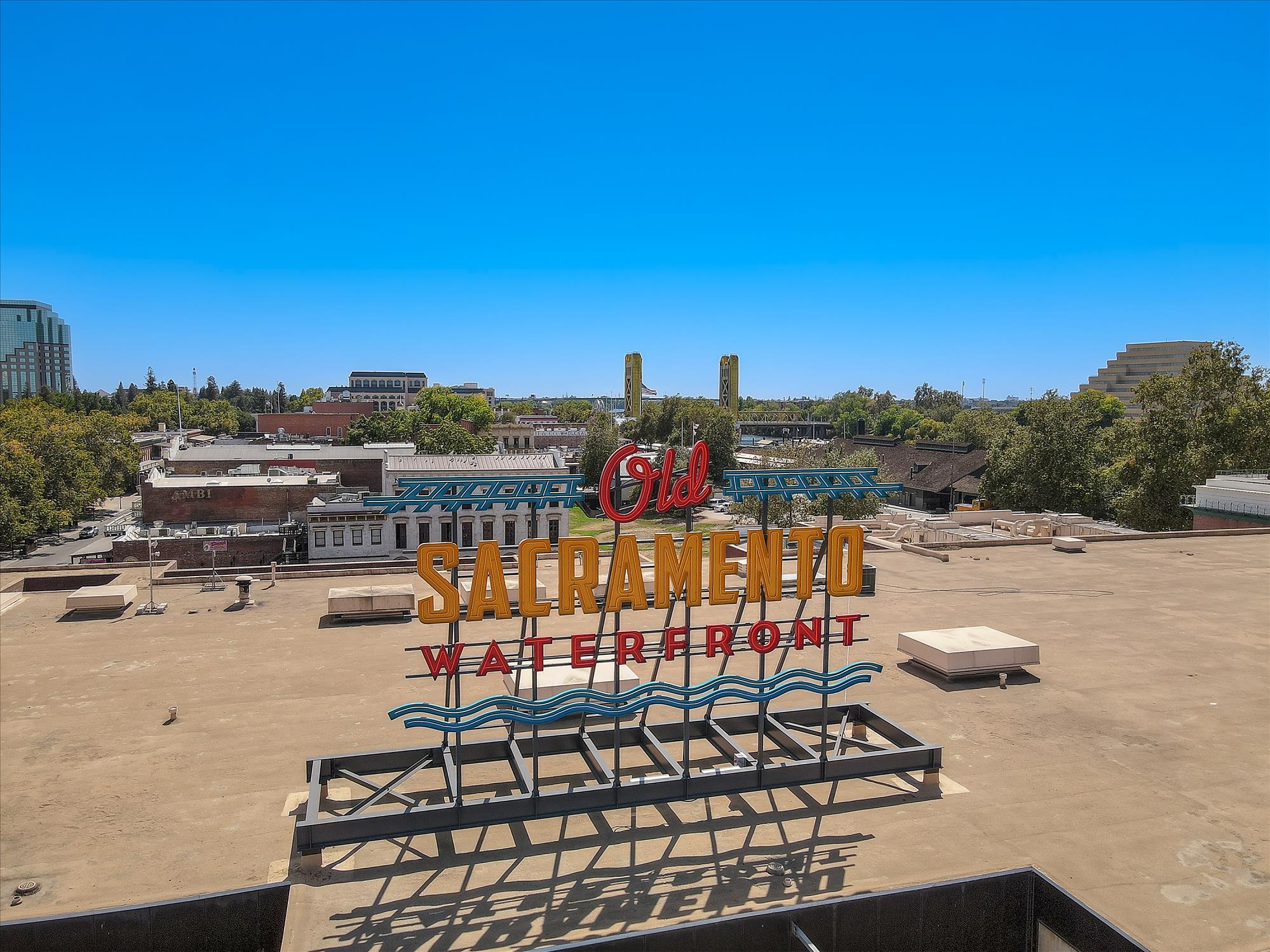 A sign in a sandy area.