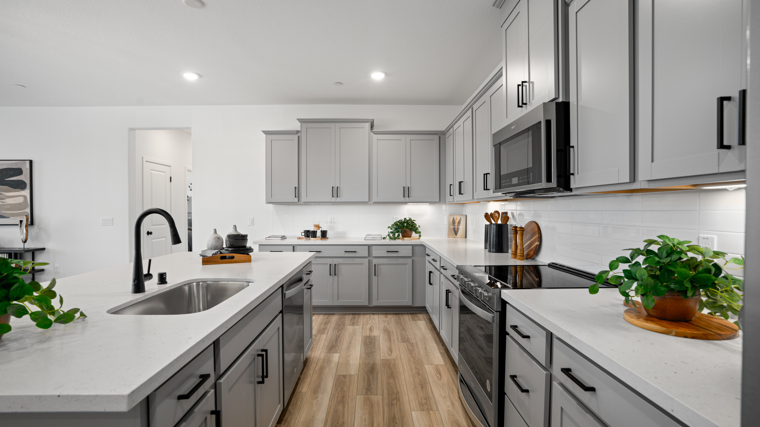 A kitchen with white cabinets.