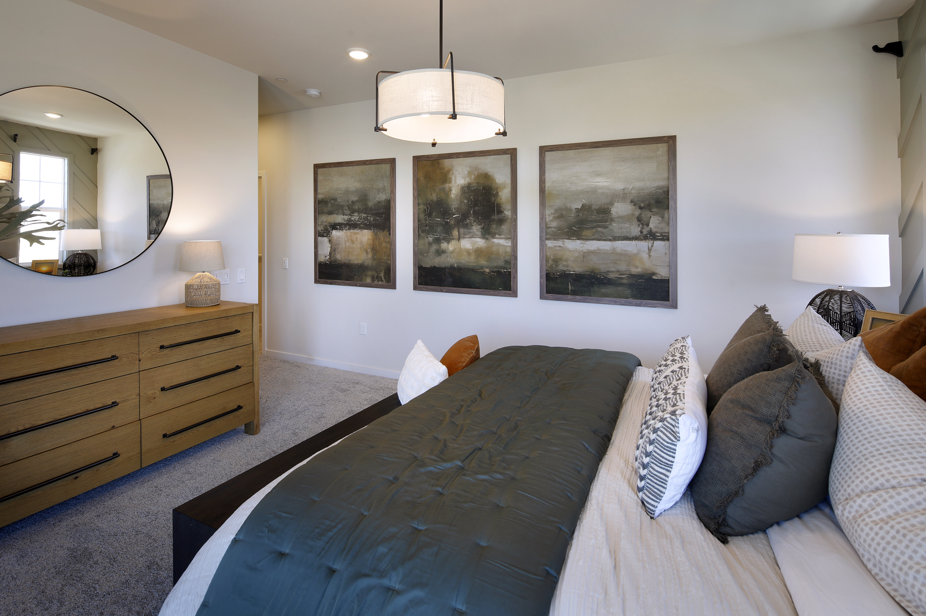 A bedroom with a bed and a mirror.