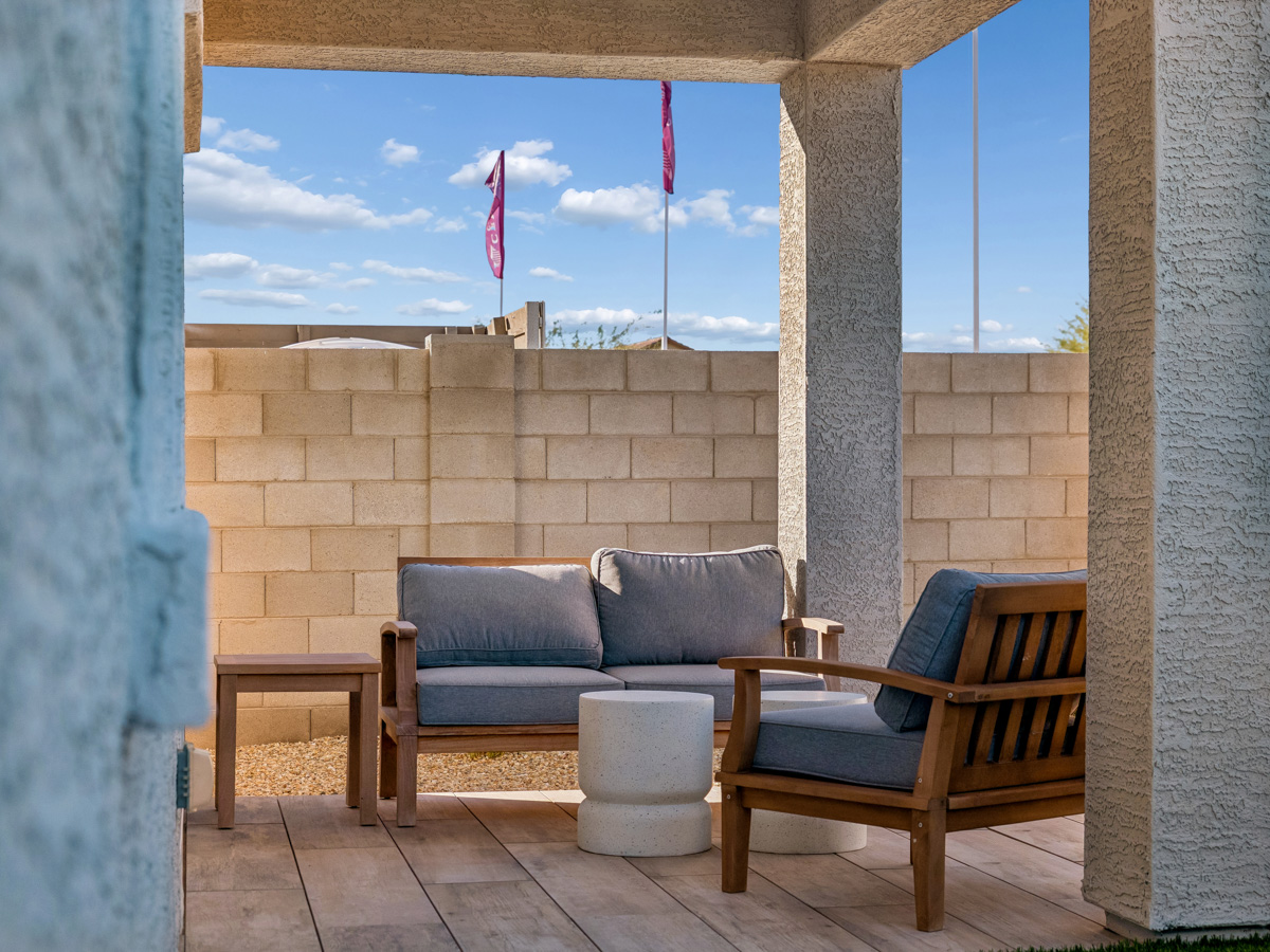 A couch and a chair on a patio.