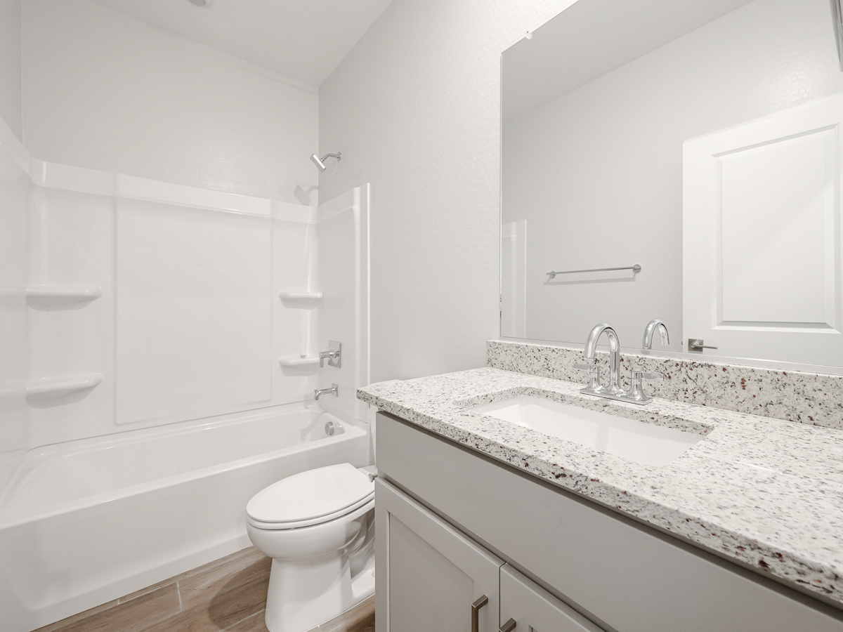 A bathroom with a marble countertop.