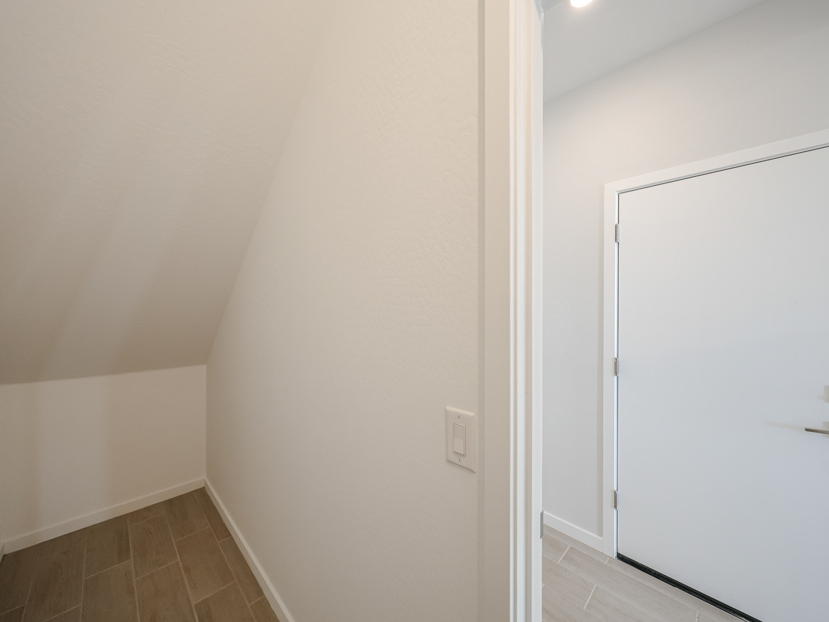 A white wall with a white door.