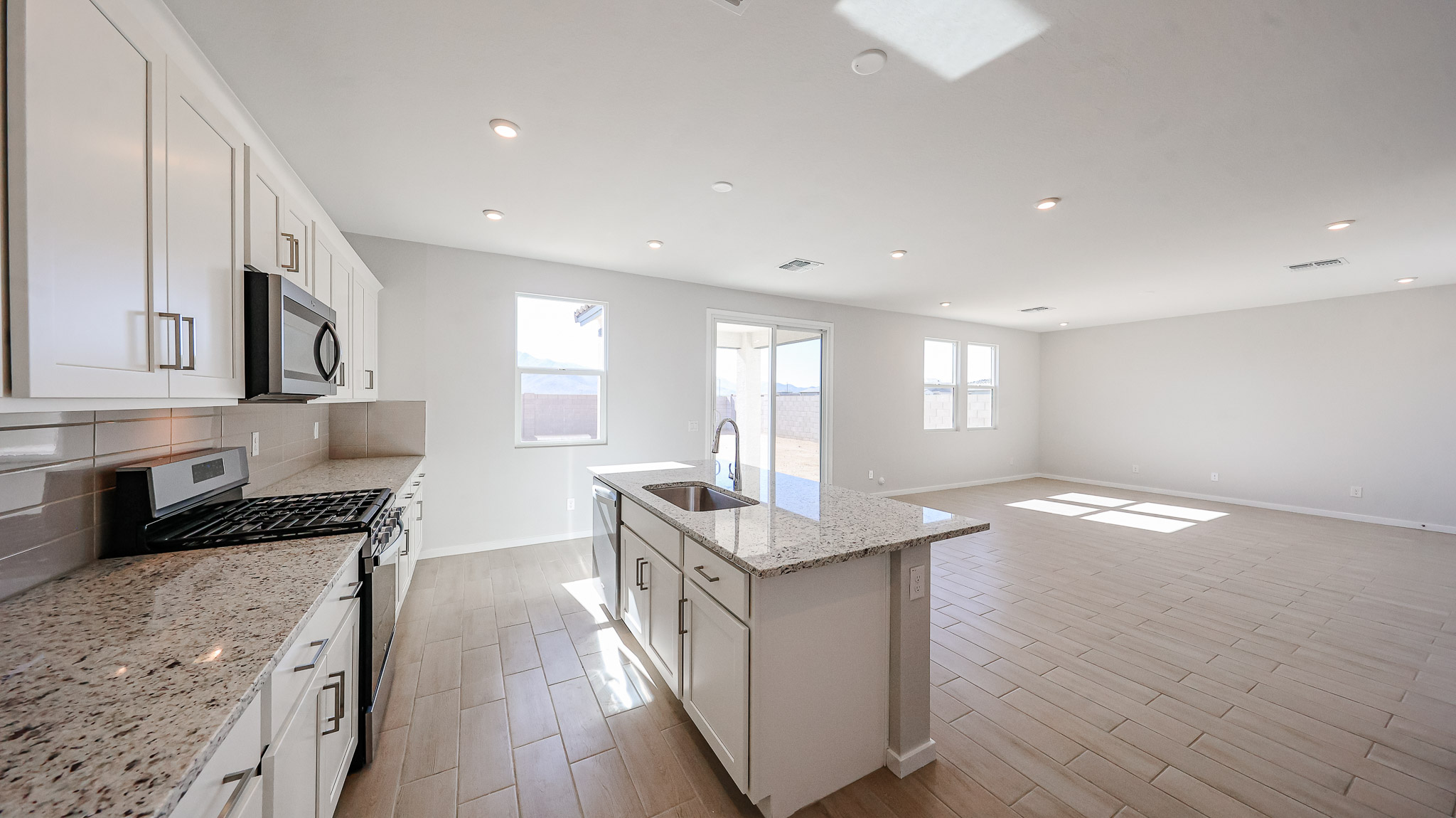 A kitchen with white cabinets.