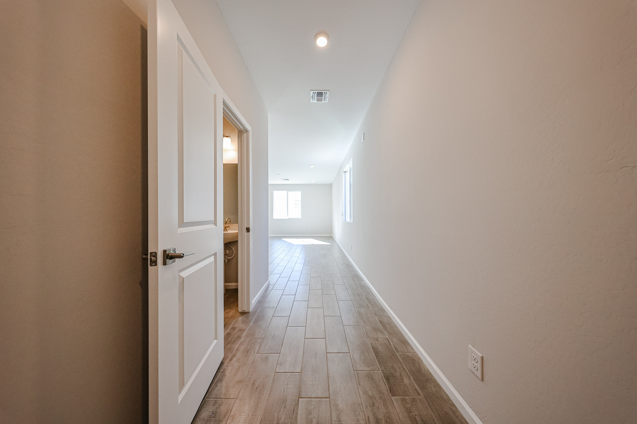 A hallway with white doors.