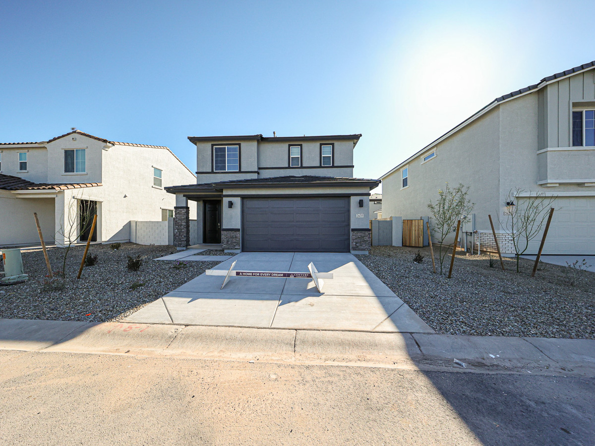 A driveway with a house in the background.