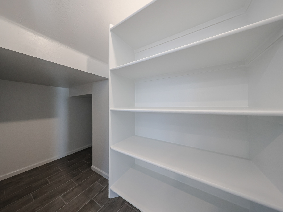 A white shelf in a room.
