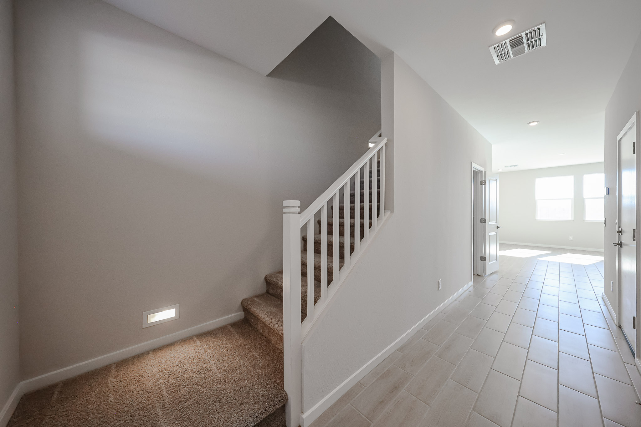 A hallway with white walls.