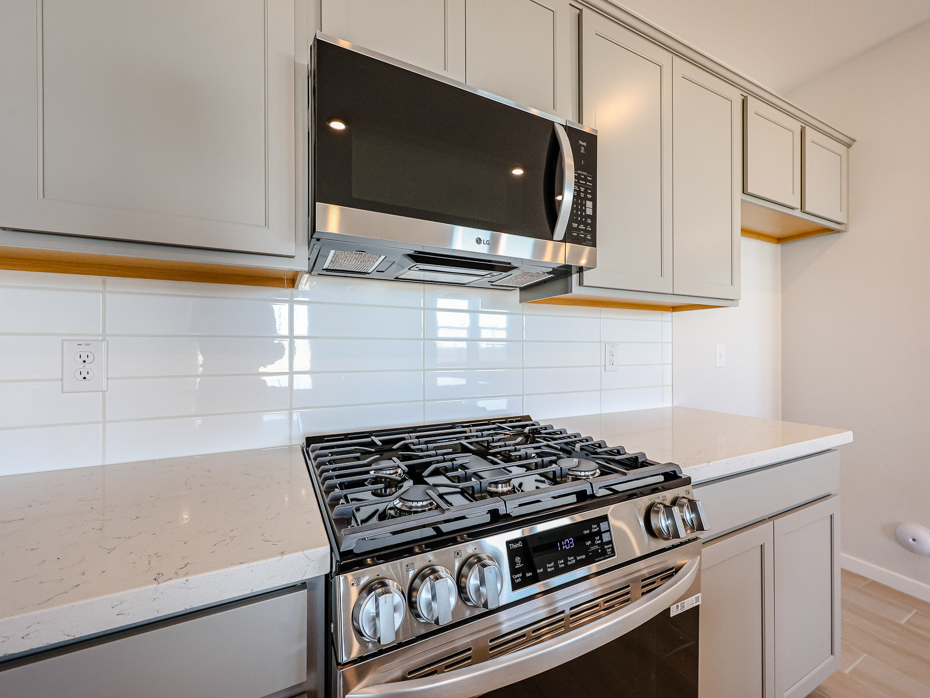 A kitchen with white cabinets.