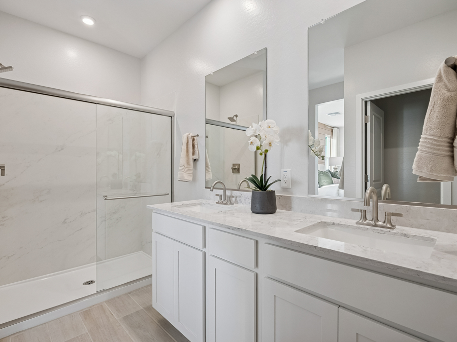 A bathroom with white cabinets.