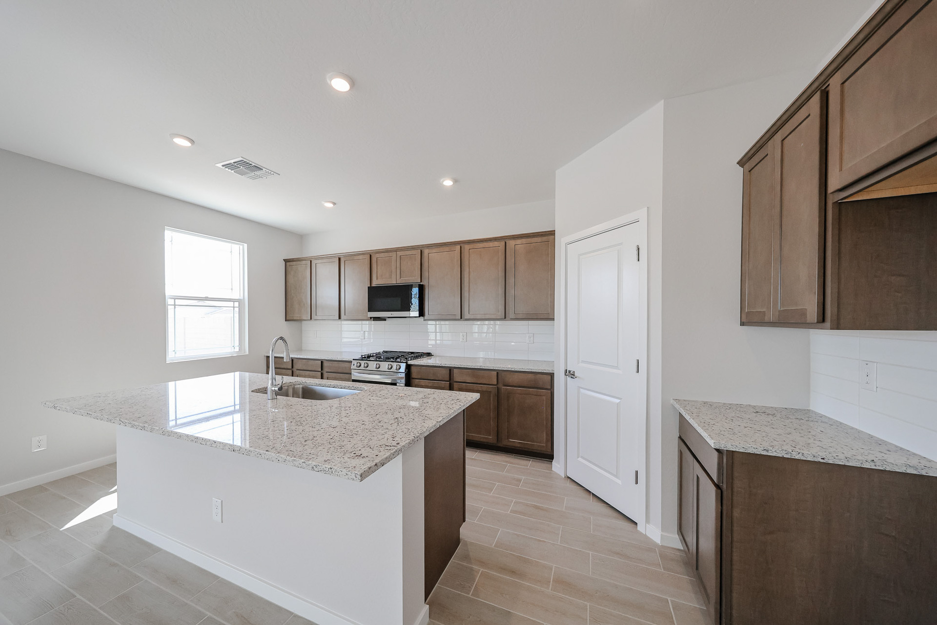 A kitchen with wooden cabinets.