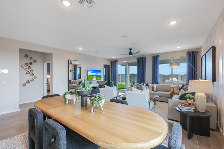A large living room with a large table and chairs.