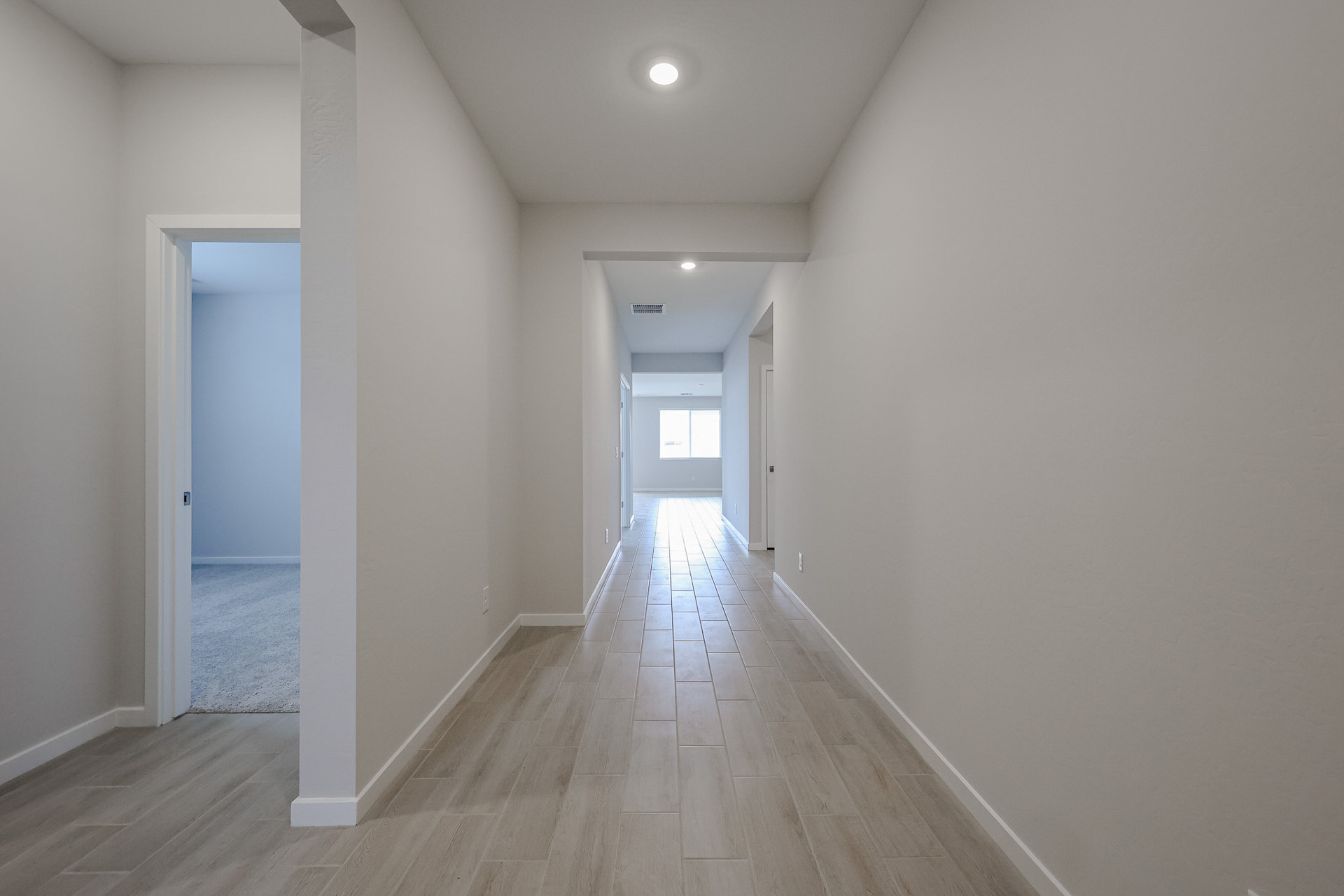 A hallway with white walls.