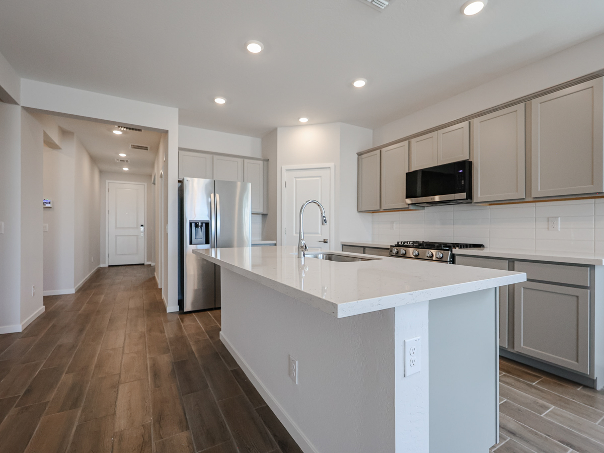 A kitchen with white cabinets.