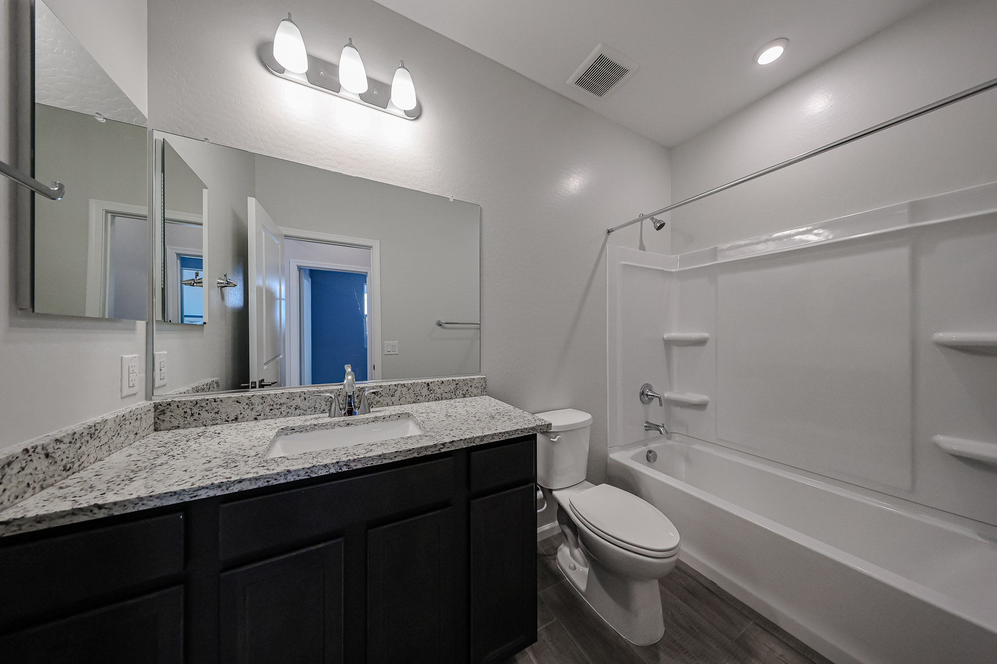 A bathroom with a tub sink and toilet.