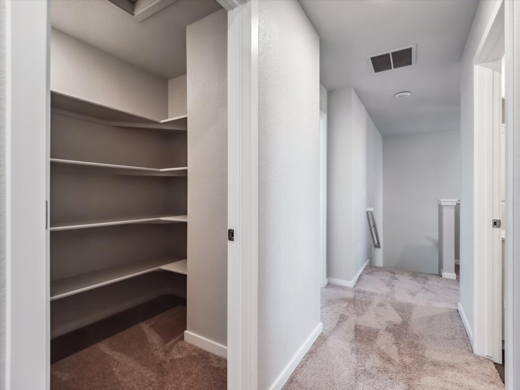 A hallway with white walls.