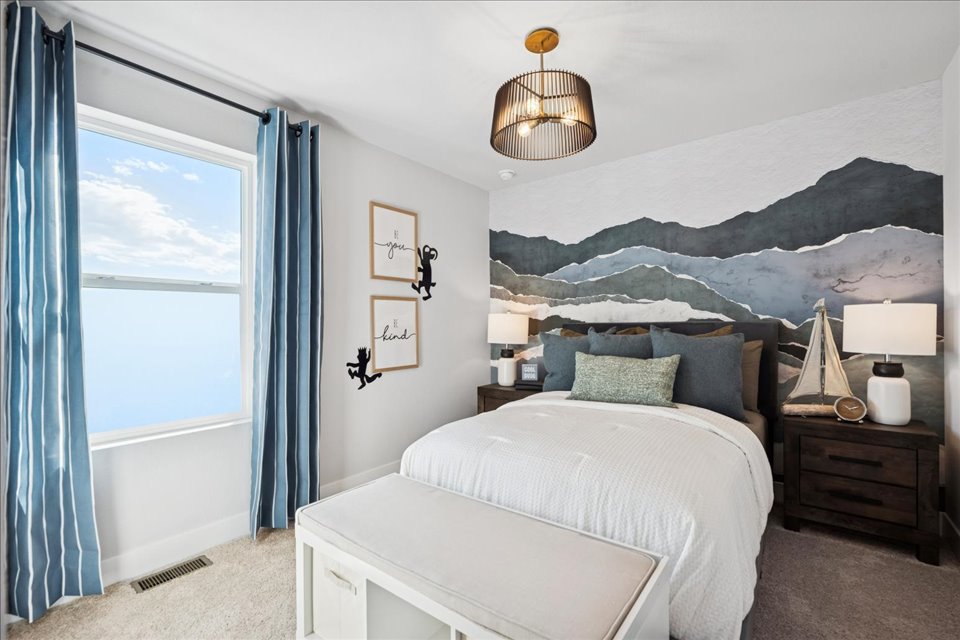 A bedroom with a bed and a window.