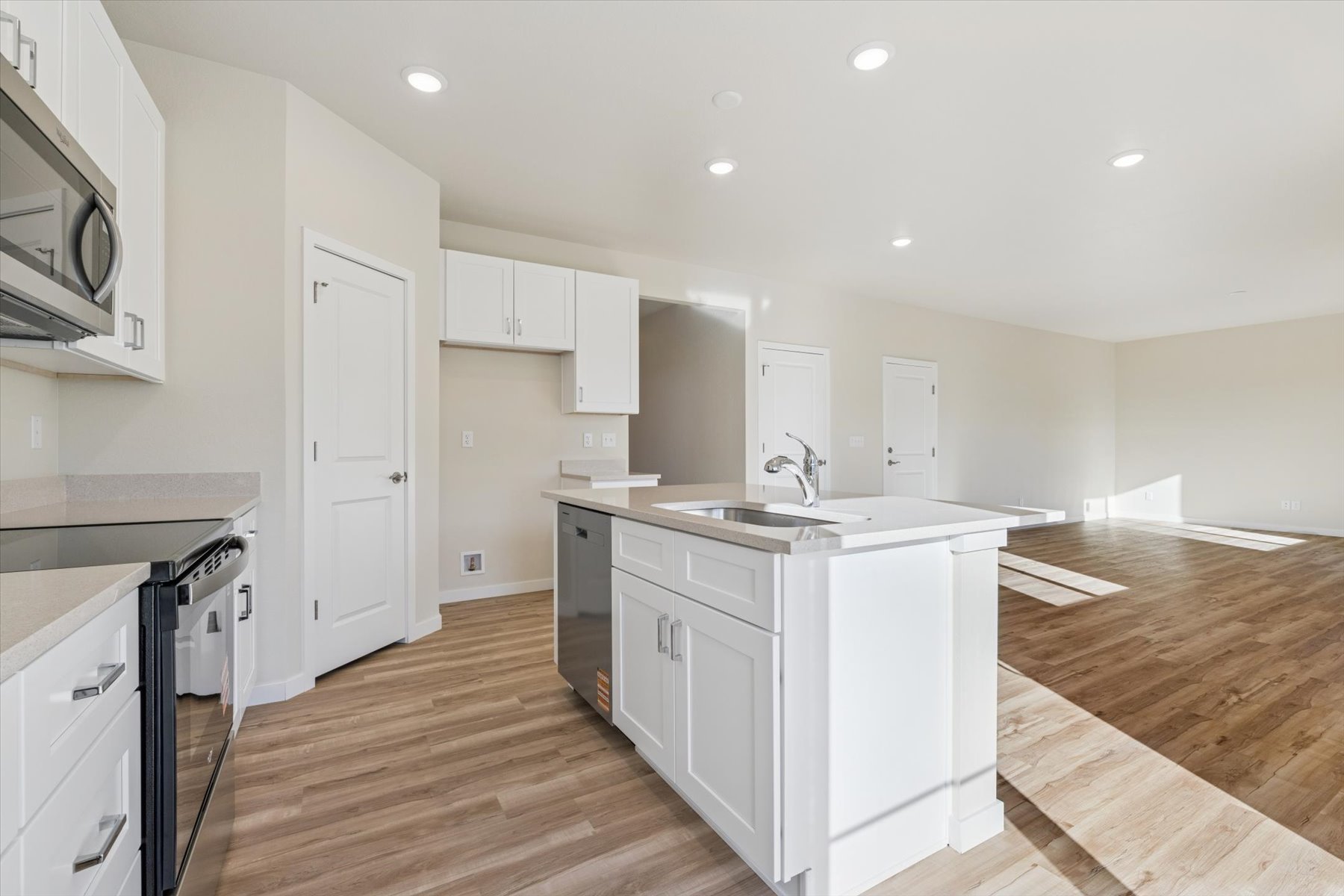 A kitchen with white cabinets.