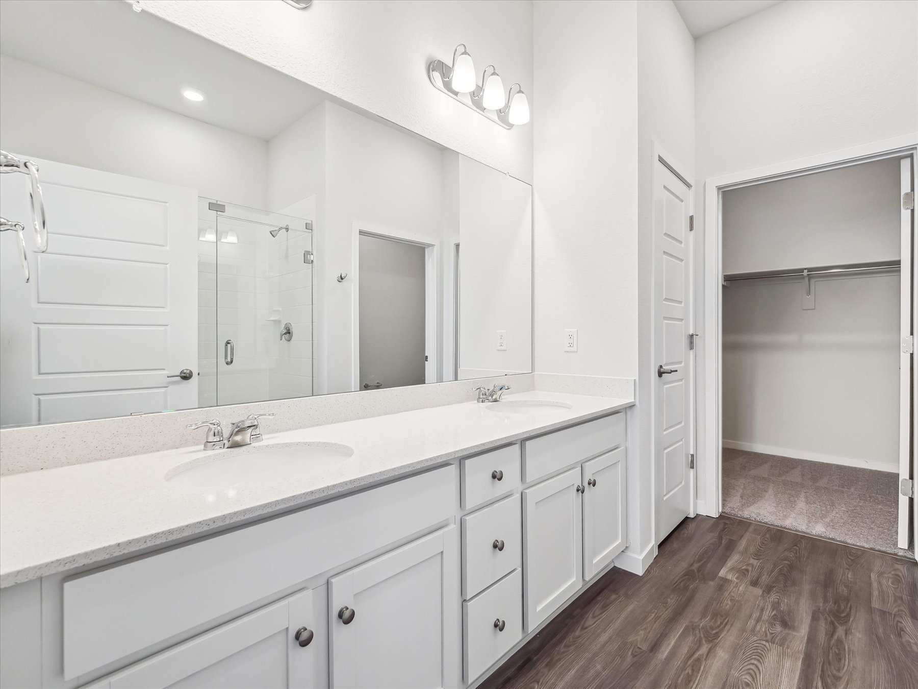A bathroom with white cabinets.