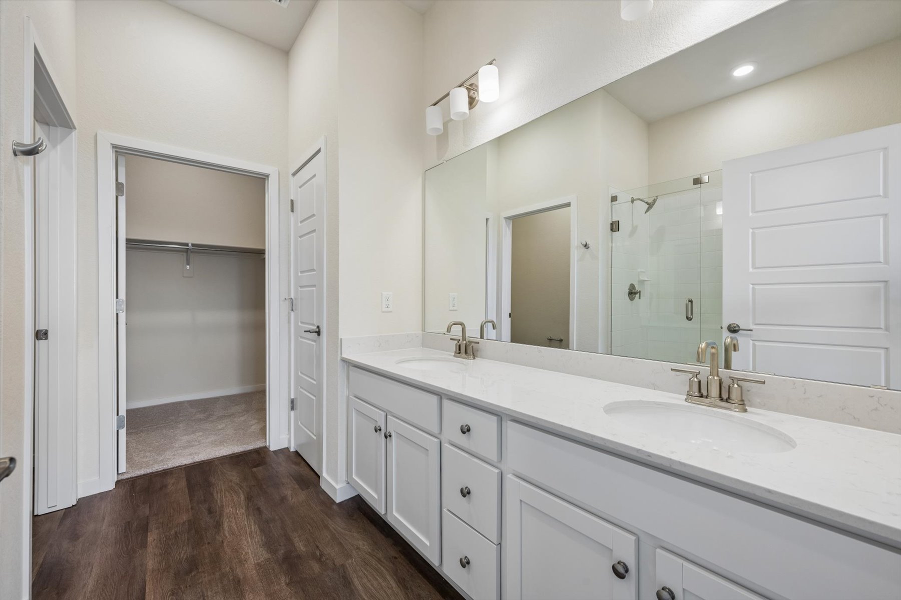 A bathroom with a large mirror.