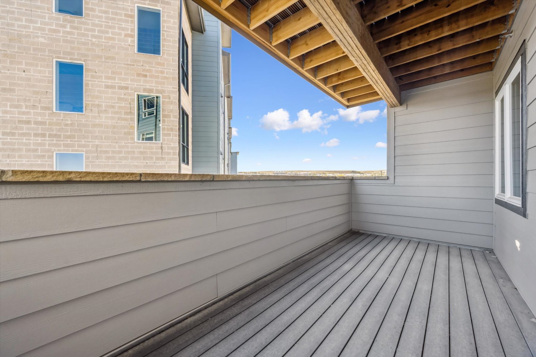 A wooden deck next to a building.