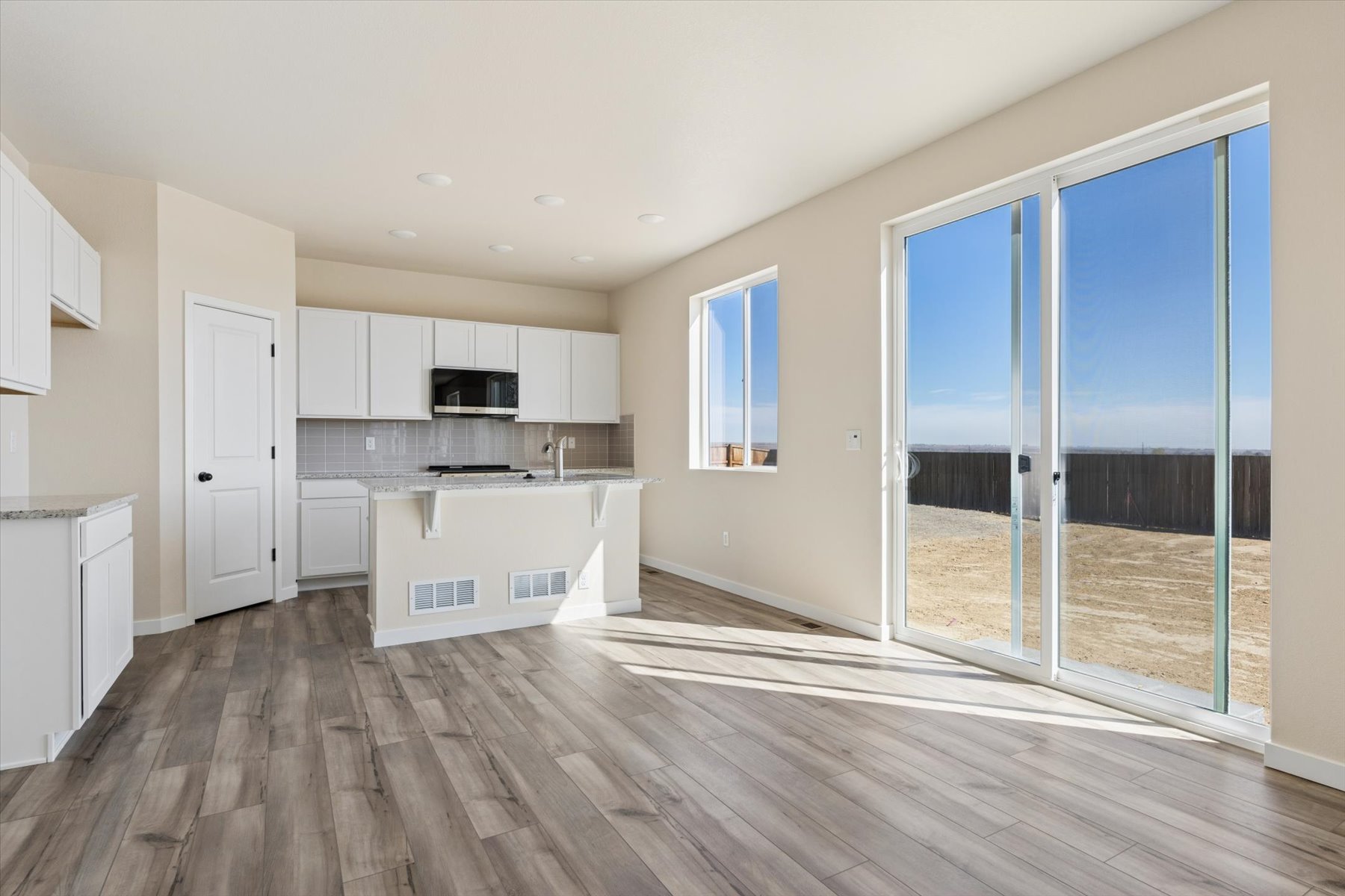 A large kitchen with a glass door.