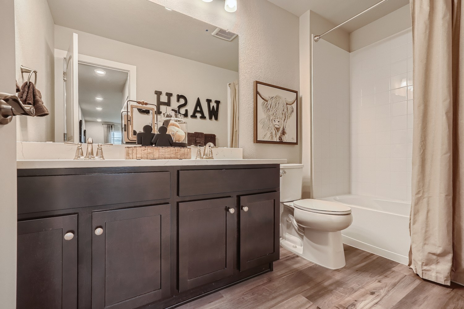 A bathroom with a large mirror.