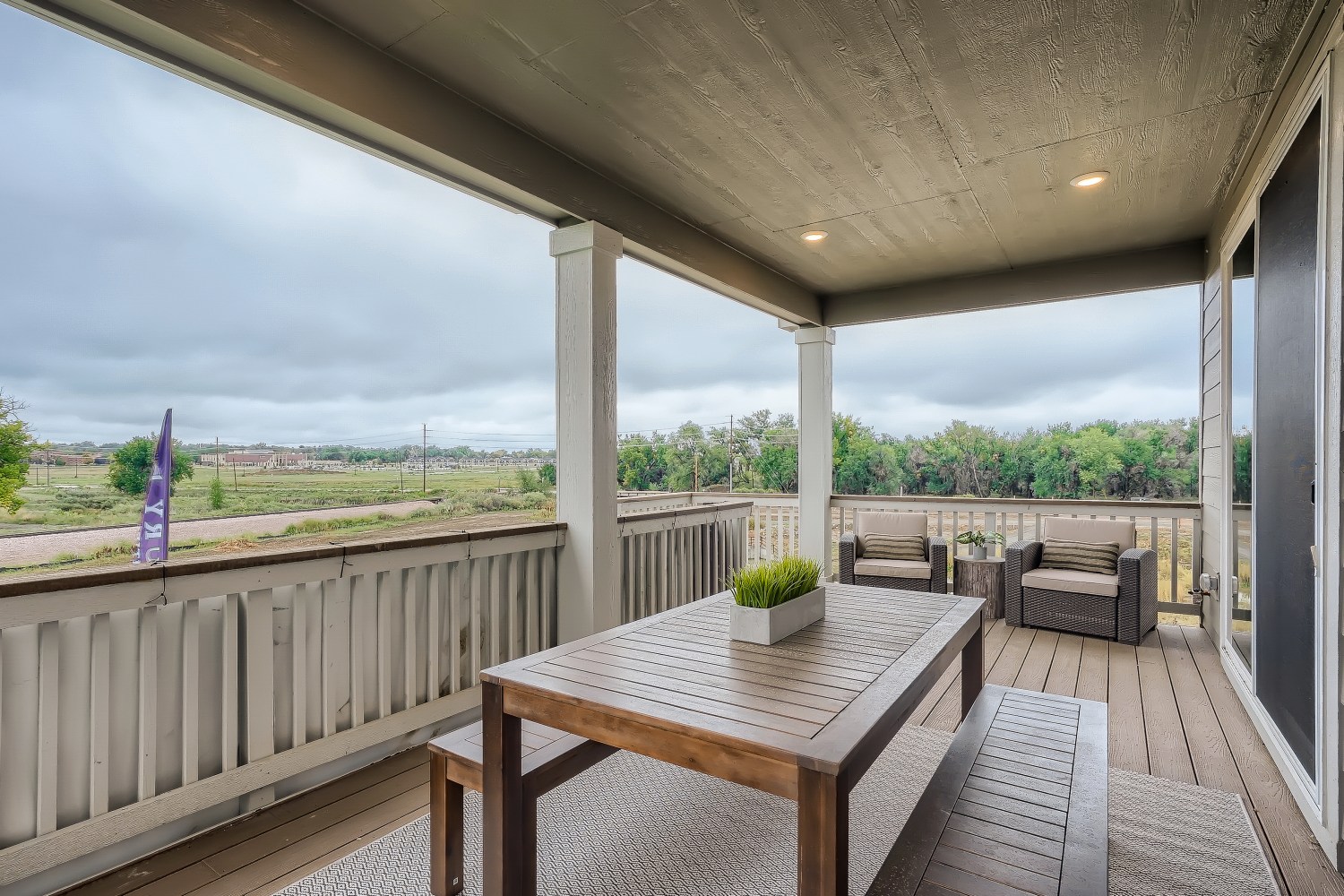 A table and chairs on a deck.