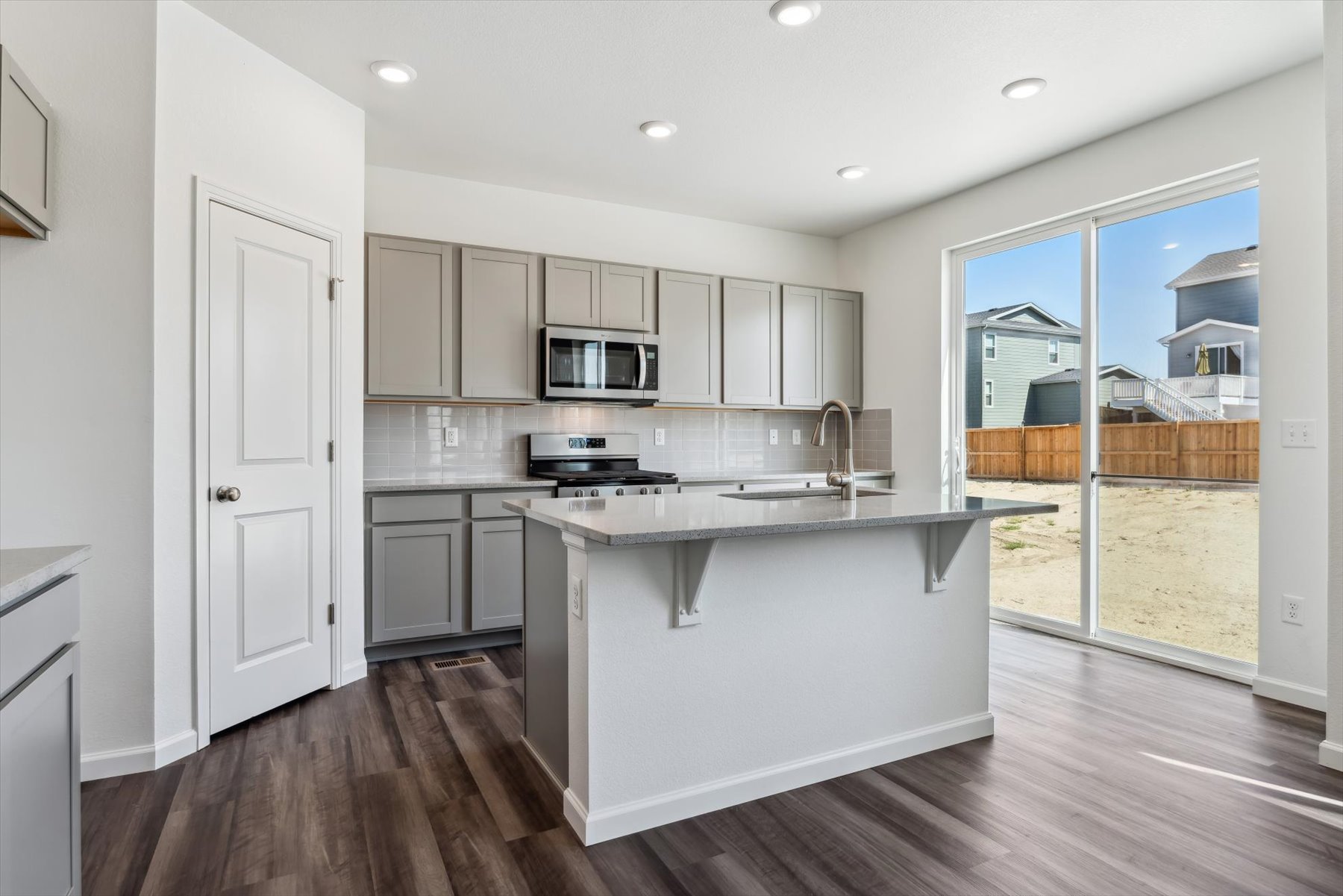 A kitchen with white cabinets.