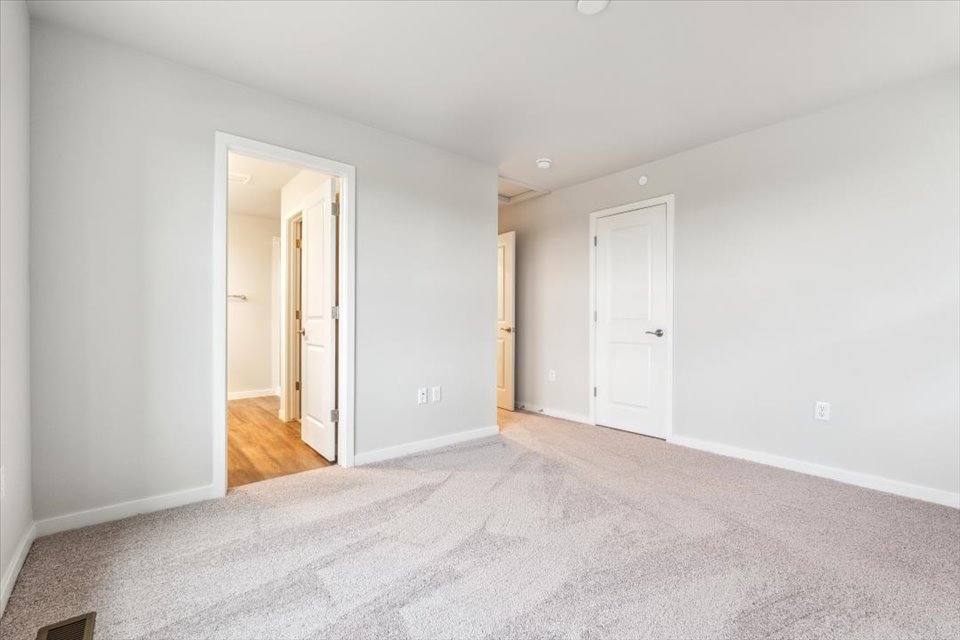 A hallway with white doors.