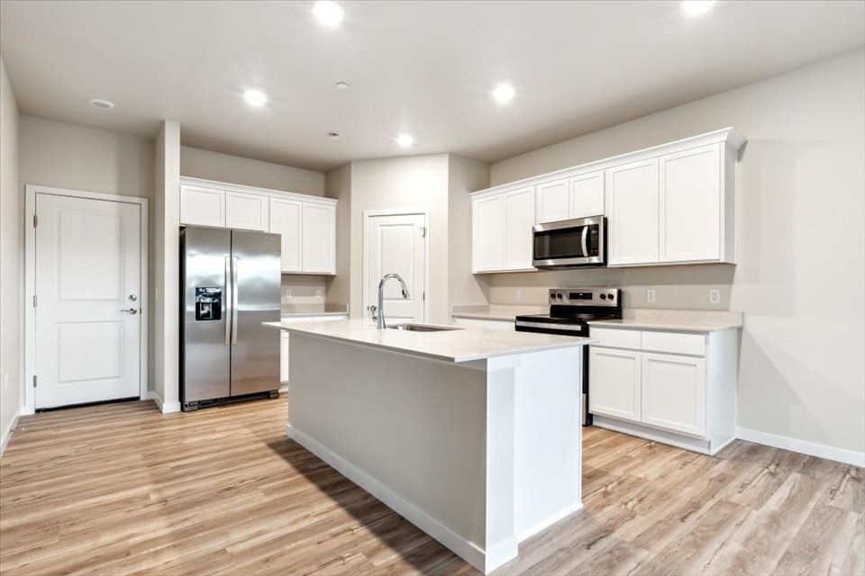 A kitchen with white cabinets.