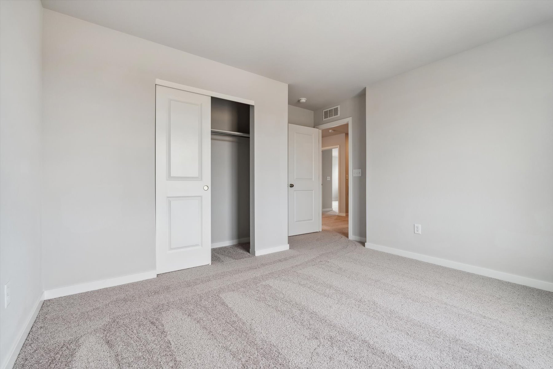 A hallway with white walls.
