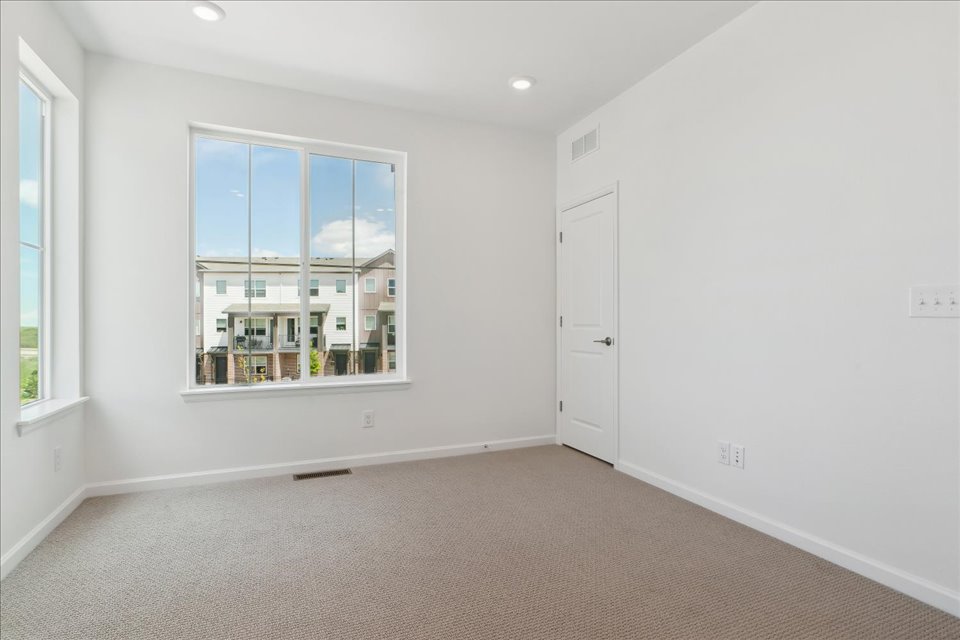 A room with a window and a door.