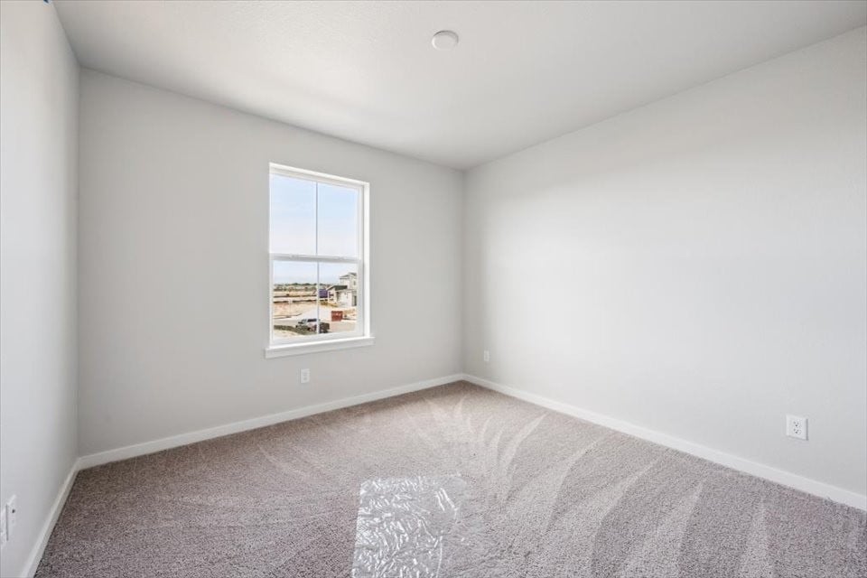 A room with a window and carpet.