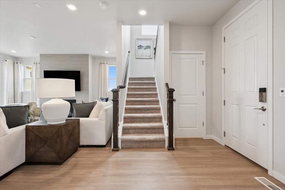 A living room with a staircase.