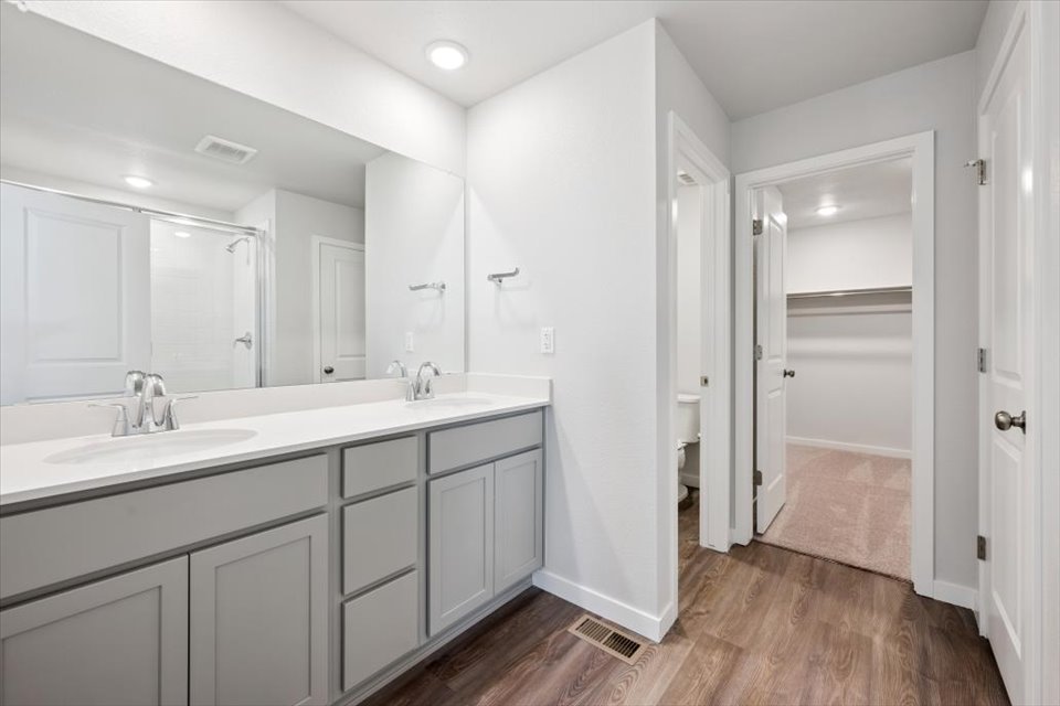 A bathroom with white cabinets.