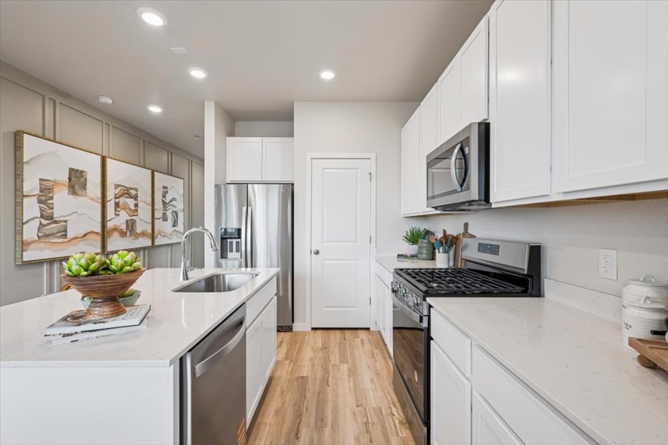 A kitchen with white cabinets.