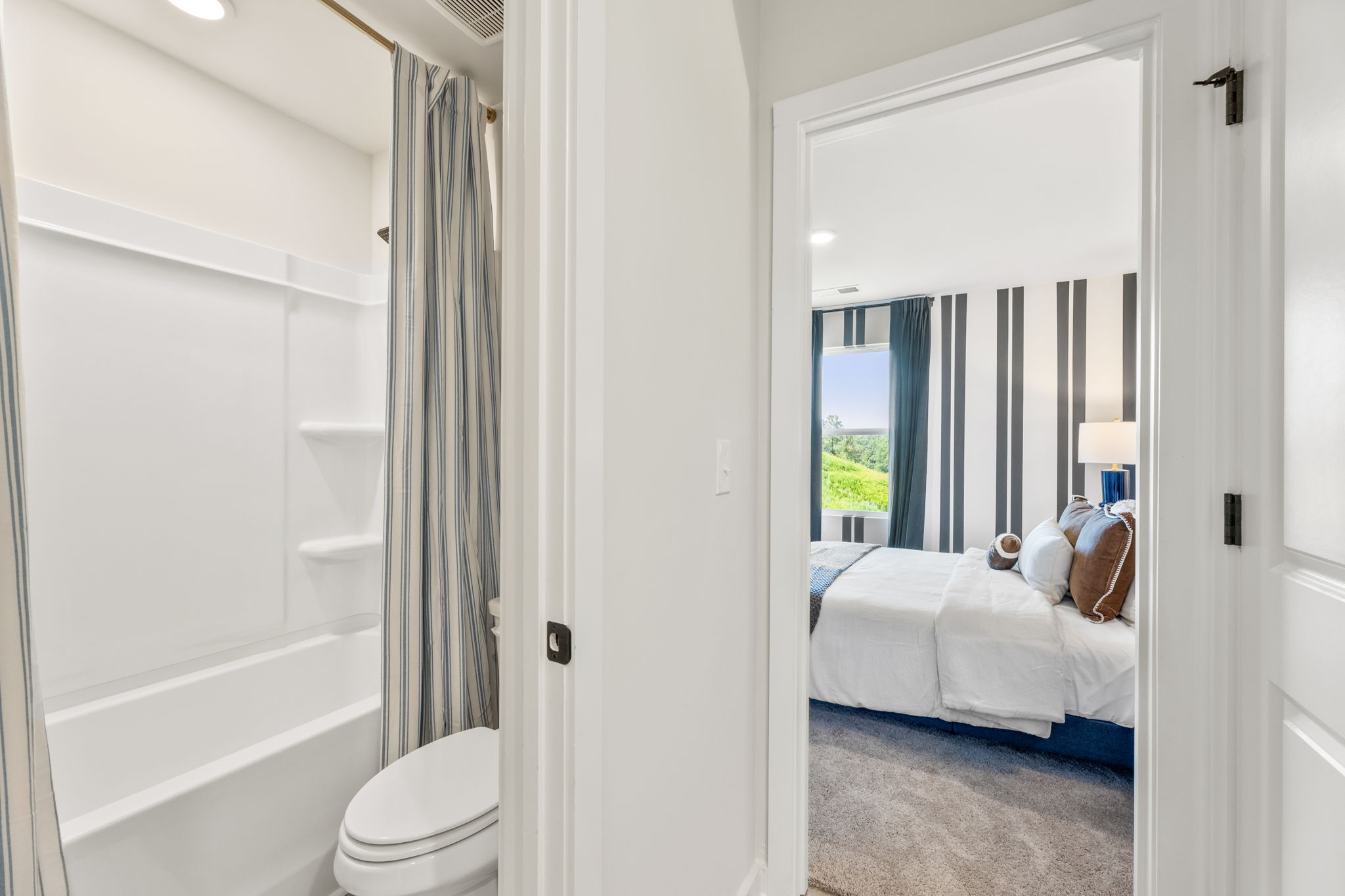 A bathroom with a bed and a bathtub.