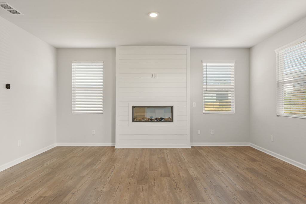 A room with white walls and a wood floor.