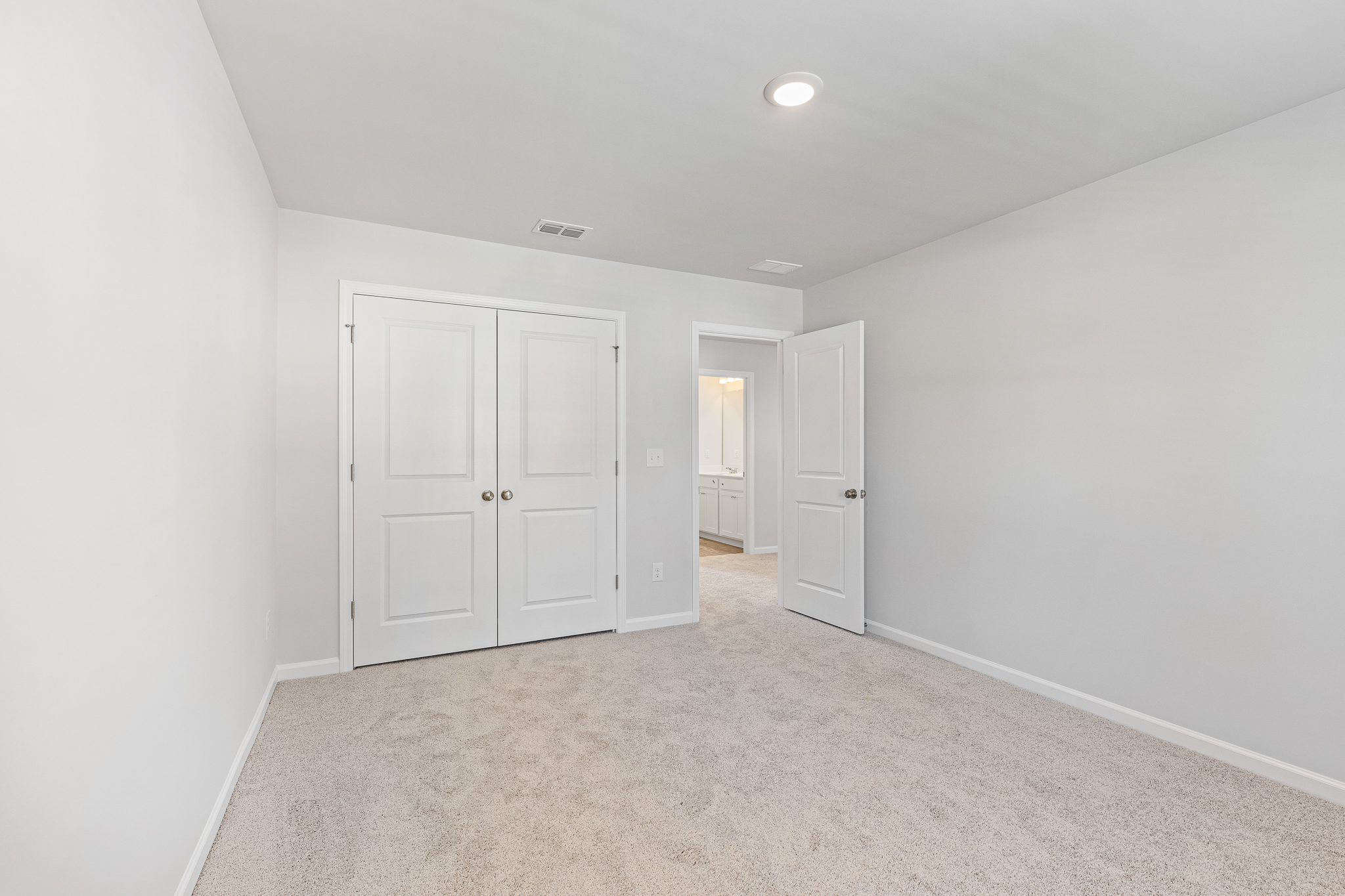 A hallway with white doors.