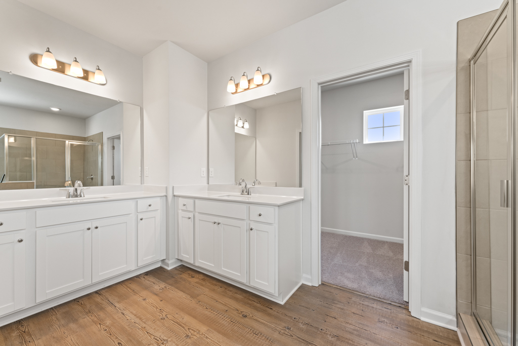 A bathroom with white cabinets.