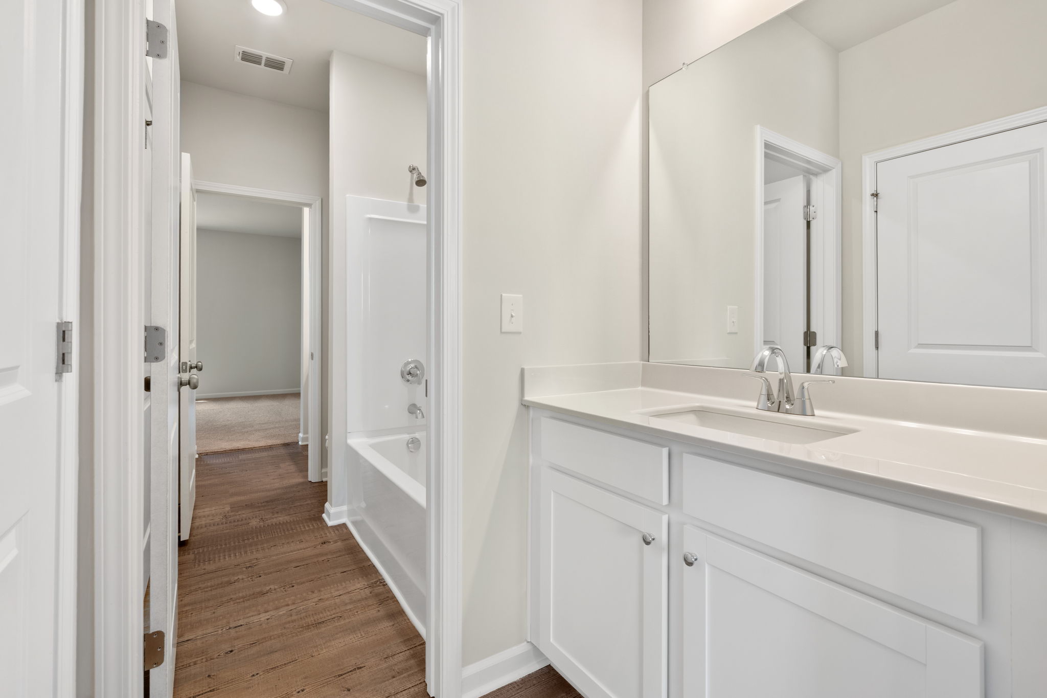 A bathroom with a sink and a mirror.