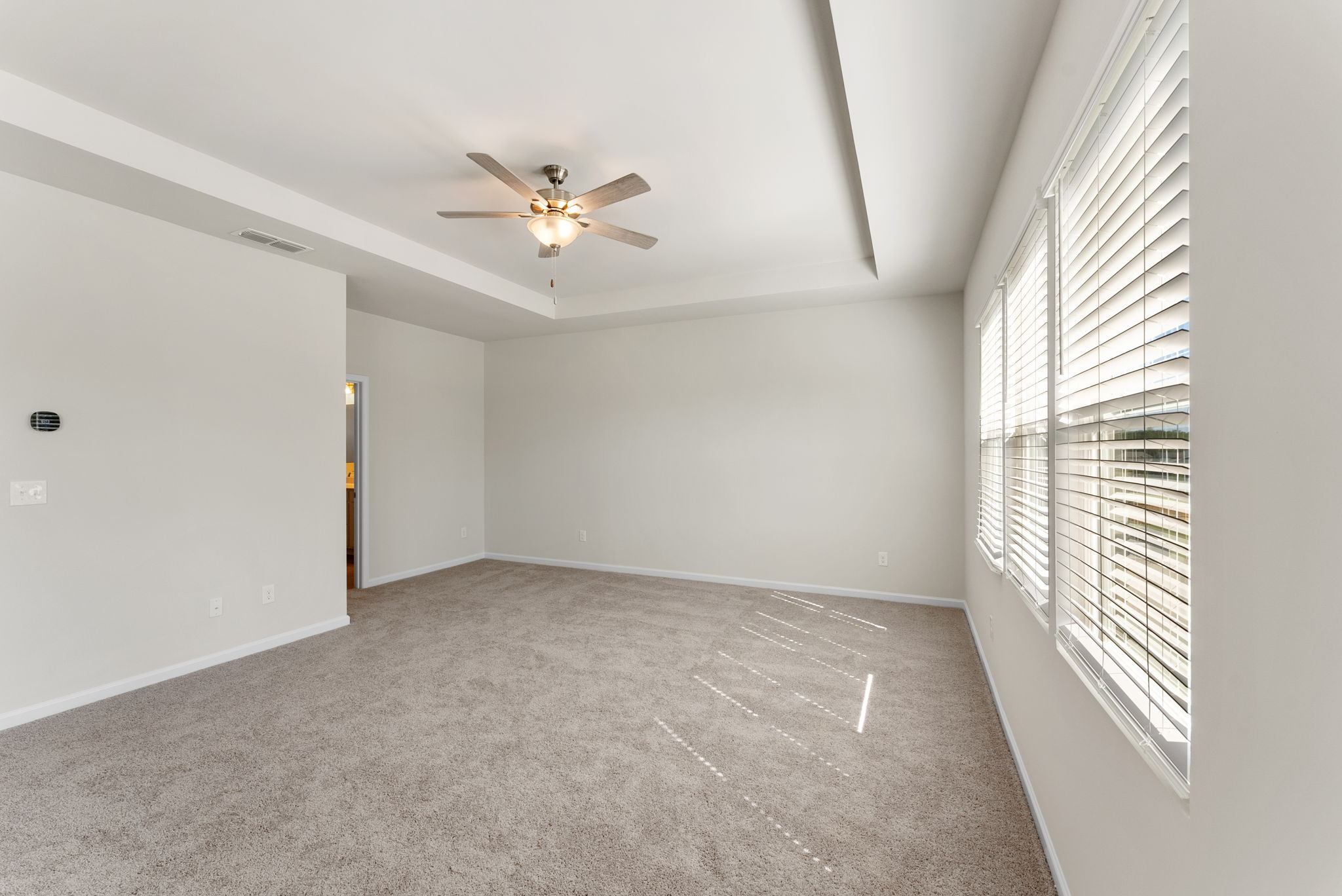 A room with a ceiling fan and a ceiling fan.